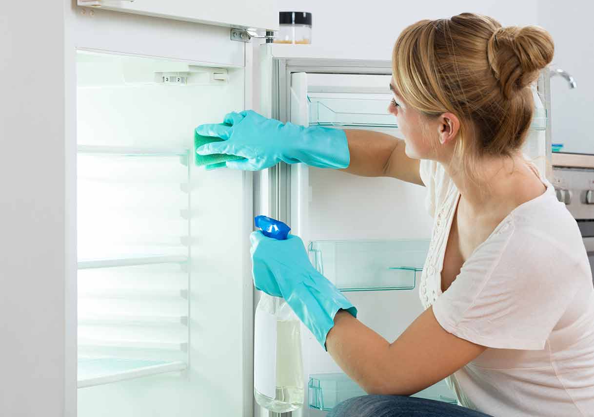 Woman Cleaning Refrigerator At eb4ac